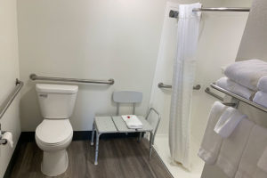 accessible guest room bathroom with roll-in shower