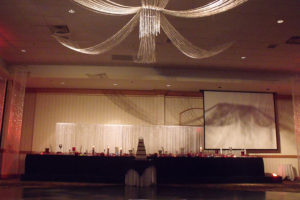 cake table next to dance floor at wedding in the Sandhills Convention Center